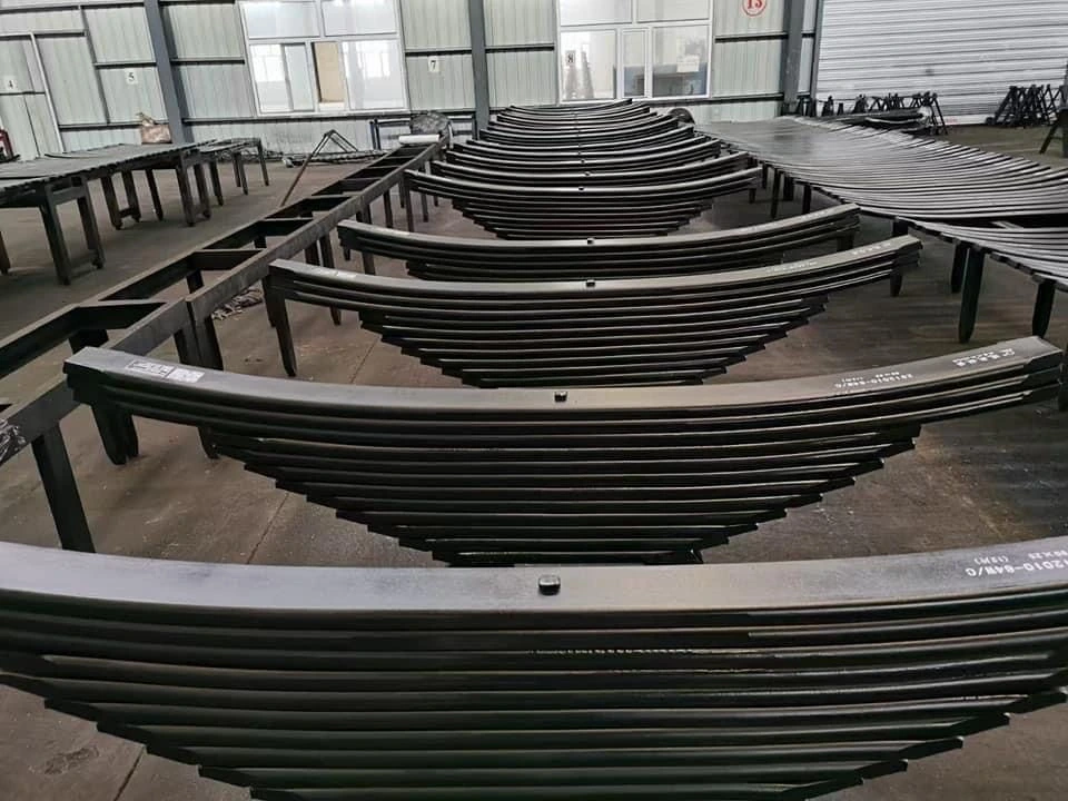 Finished black leaf springs organised in production racks